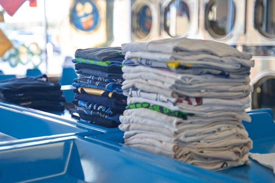 Freshly folded shirts stacked after cleaning