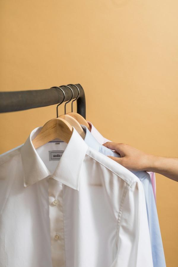 Pressed white dress shirt hanging neatly